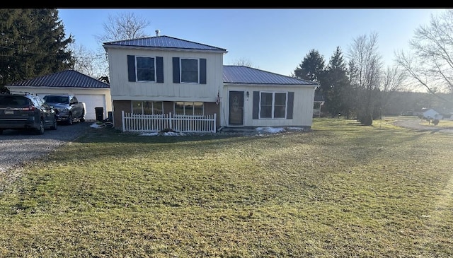 view of front of property featuring a garage, covered porch, and a front yard