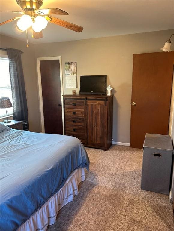 bedroom with ceiling fan and light carpet