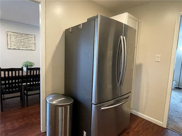 kitchen featuring white cabinetry, dark hardwood / wood-style floors, and stainless steel refrigerator