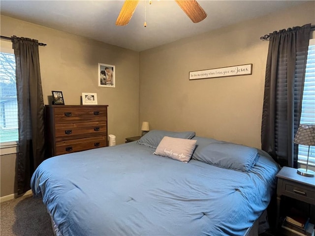 bedroom with multiple windows, carpet floors, and ceiling fan