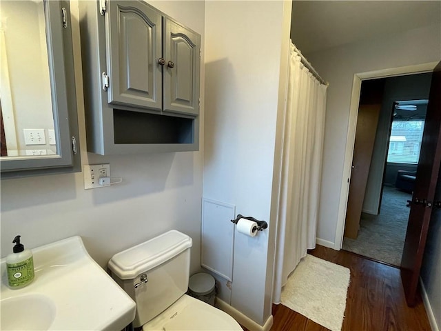 bathroom featuring hardwood / wood-style floors and toilet