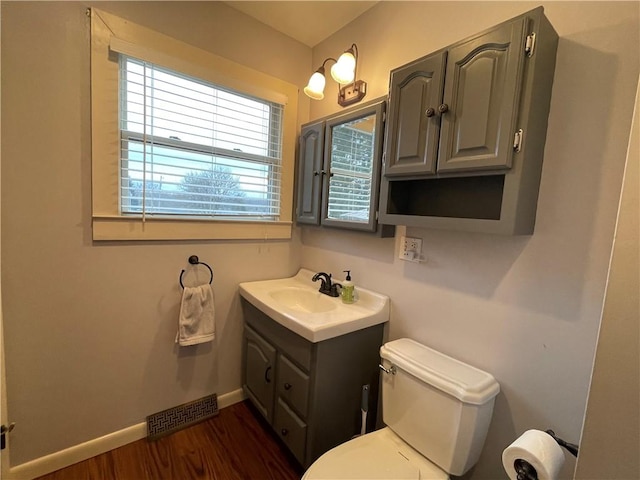 bathroom featuring hardwood / wood-style flooring, vanity, and toilet