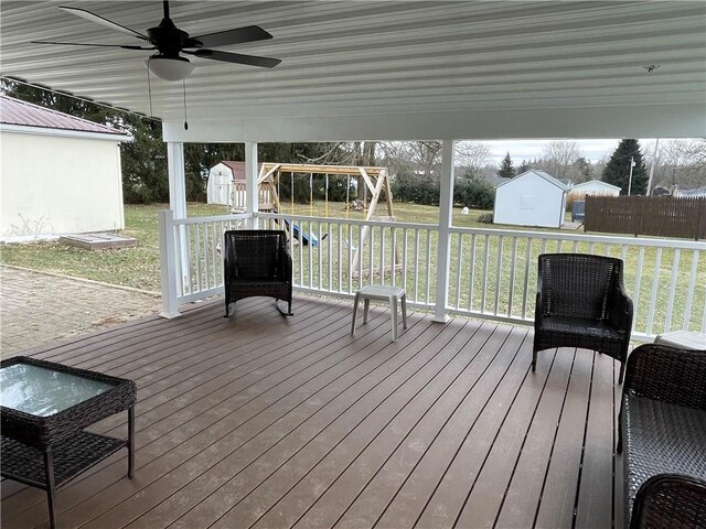 unfurnished sunroom with ceiling fan