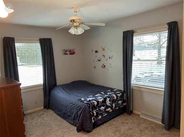 bedroom with ceiling fan and light carpet