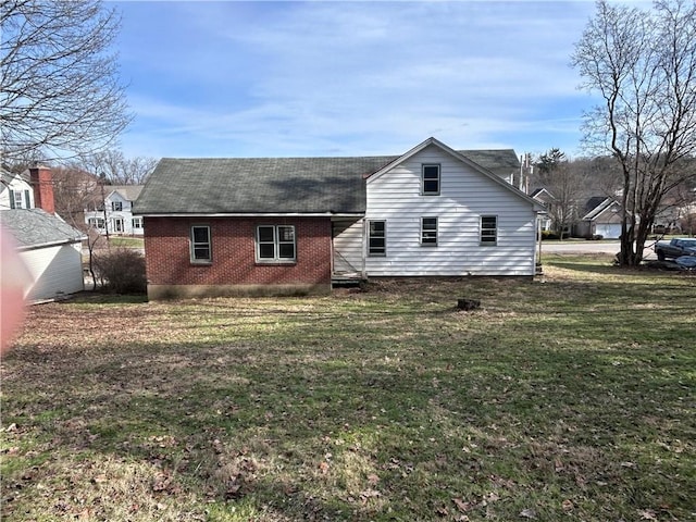 rear view of property featuring a yard