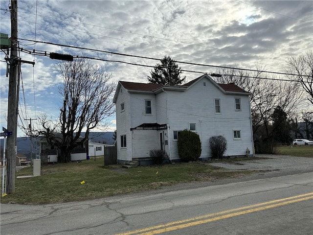 view of side of home featuring a lawn