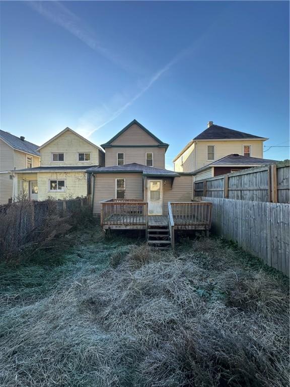 rear view of house with a wooden deck