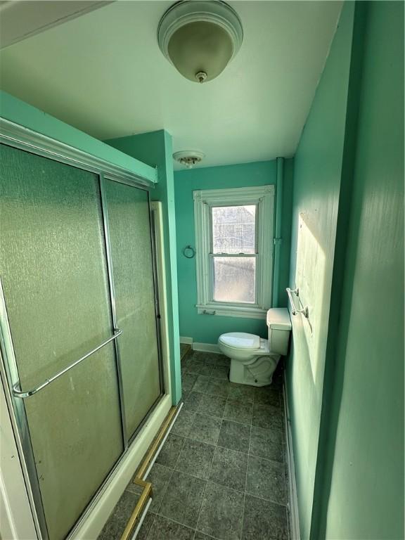 bathroom featuring toilet and walk in shower