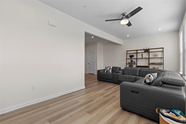 living room featuring ceiling fan and light hardwood / wood-style flooring