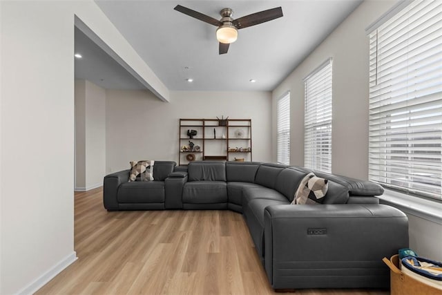 living room featuring light hardwood / wood-style flooring and ceiling fan