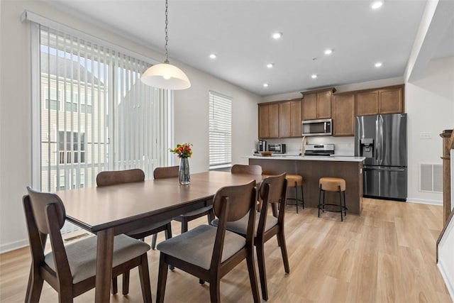 dining room with light hardwood / wood-style flooring