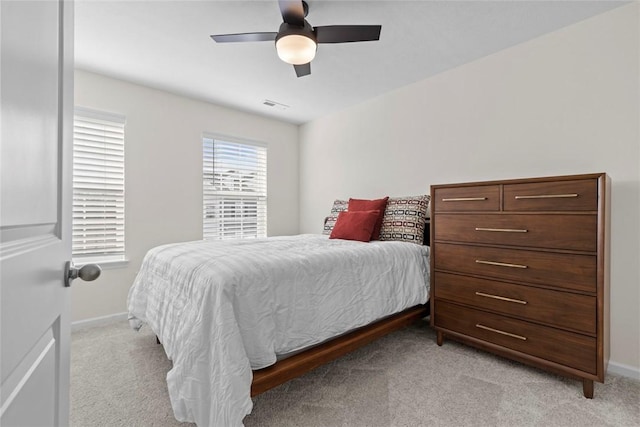 bedroom with ceiling fan and light colored carpet