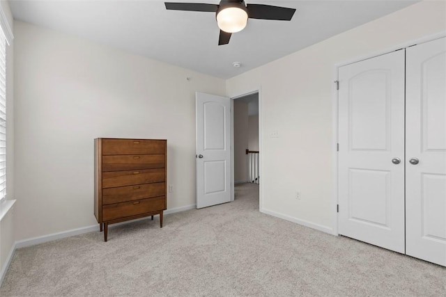 unfurnished bedroom featuring ceiling fan and light colored carpet