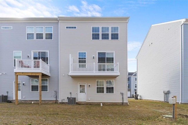 rear view of property featuring a yard and central AC unit