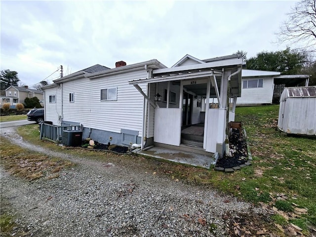 back of house featuring central AC