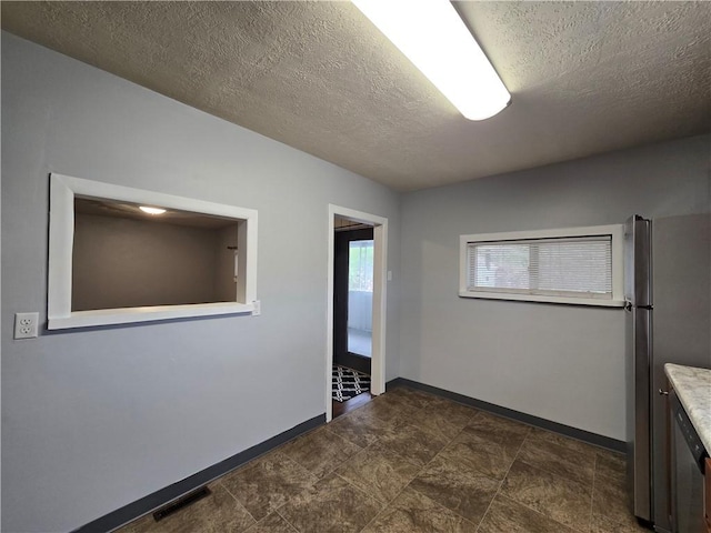 spare room with a textured ceiling