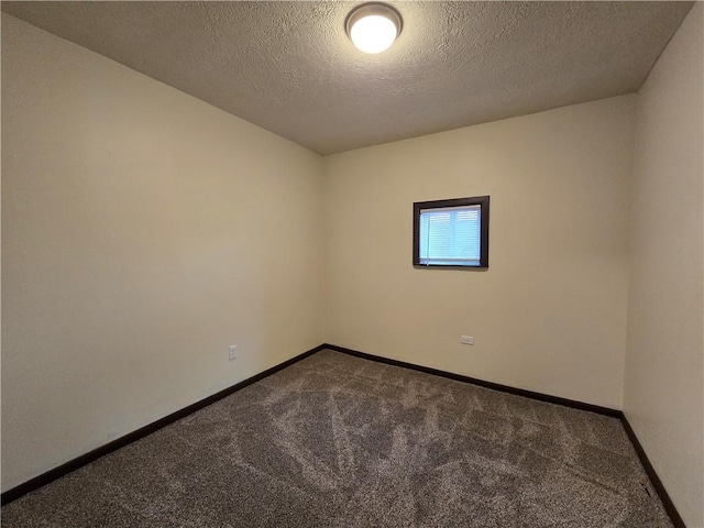 spare room featuring carpet floors and a textured ceiling