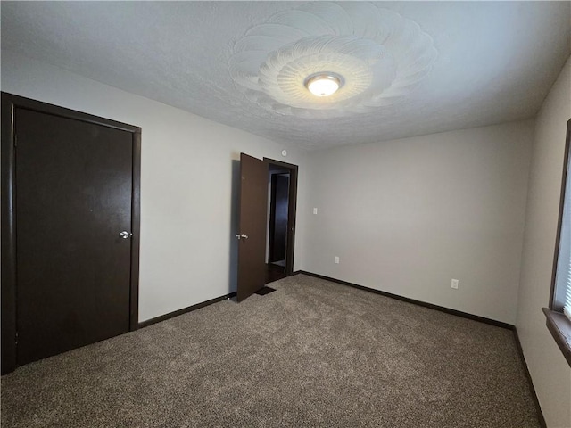 unfurnished bedroom featuring carpet floors and a textured ceiling