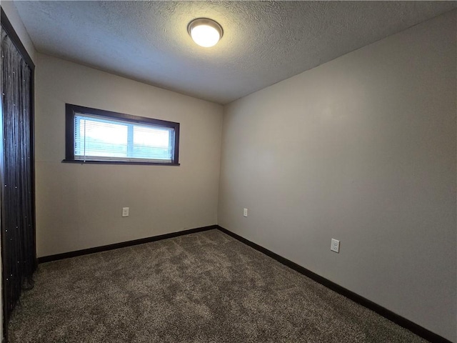 carpeted spare room featuring a textured ceiling