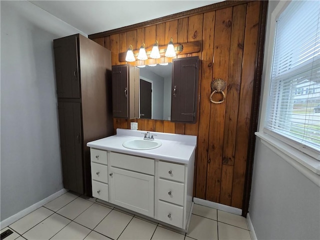 bathroom with tile patterned flooring, vanity, and wood walls