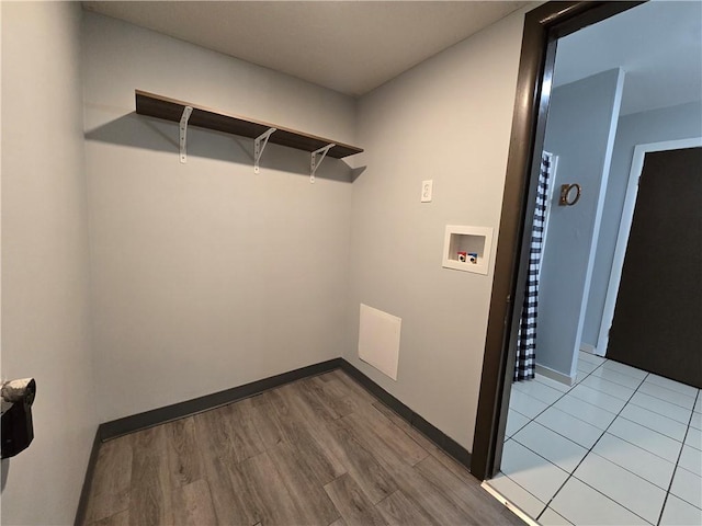 washroom featuring hookup for a washing machine and light wood-type flooring