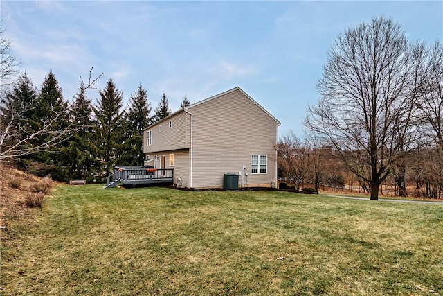 view of property exterior featuring a wooden deck, central AC, and a lawn