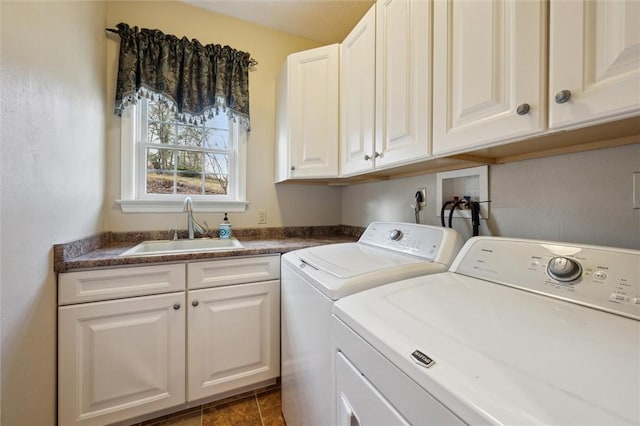 washroom with sink, cabinets, and washing machine and clothes dryer