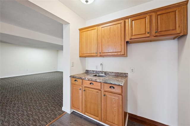 kitchen with dark carpet and sink