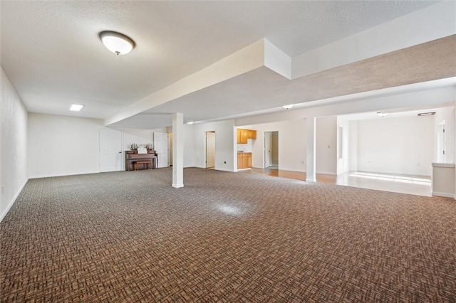 basement featuring carpet floors and a textured ceiling