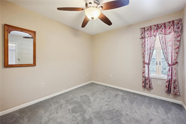 empty room featuring ceiling fan and carpet