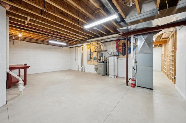 basement with heating unit, gas water heater, and electric panel