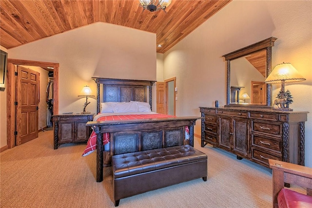 bedroom featuring light carpet, wood ceiling, and a spacious closet