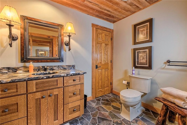 bathroom featuring vanity, wooden ceiling, and toilet