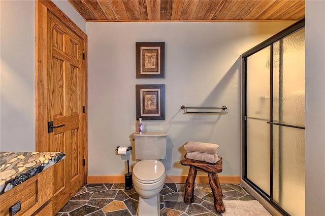 bathroom with toilet, wood ceiling, and a shower with shower door