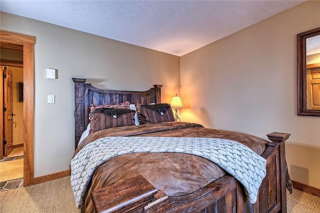 bedroom with light carpet and a textured ceiling