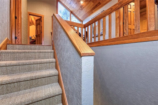 stairs with vaulted ceiling and wood ceiling