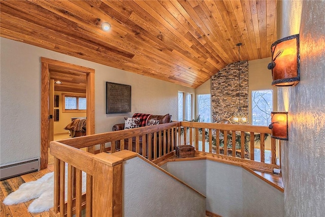 corridor with lofted ceiling, a wealth of natural light, wooden ceiling, and light hardwood / wood-style floors