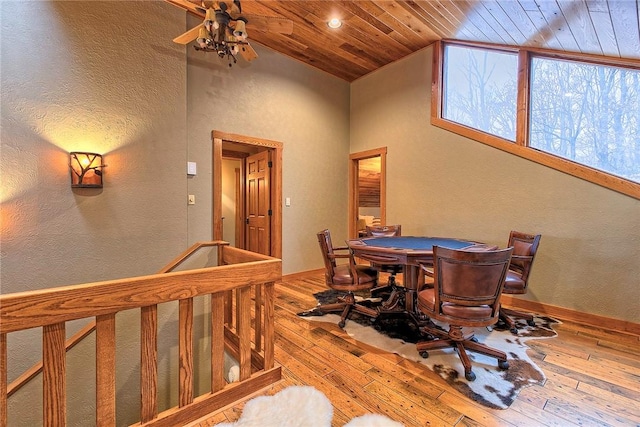 dining room featuring hardwood / wood-style flooring, high vaulted ceiling, and wood ceiling