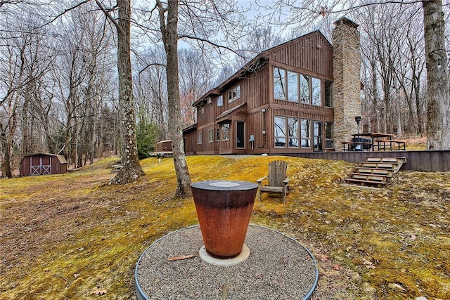 exterior space featuring a wooden deck and a storage unit