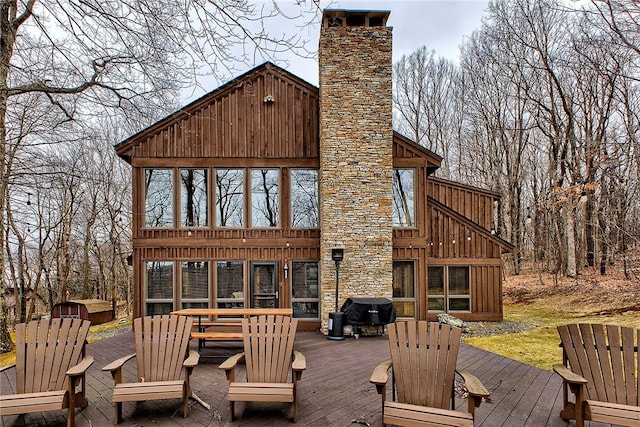 deck featuring a grill and a sunroom