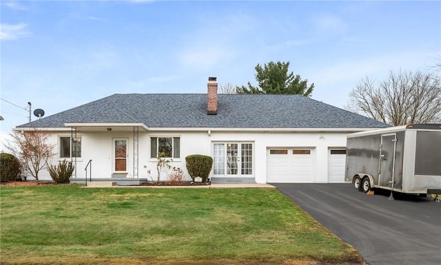 view of front of property with a garage and a front yard