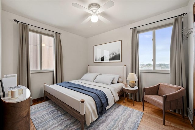 bedroom with hardwood / wood-style flooring and ceiling fan