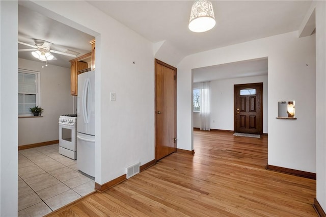 kitchen with white appliances, light hardwood / wood-style floors, and ceiling fan