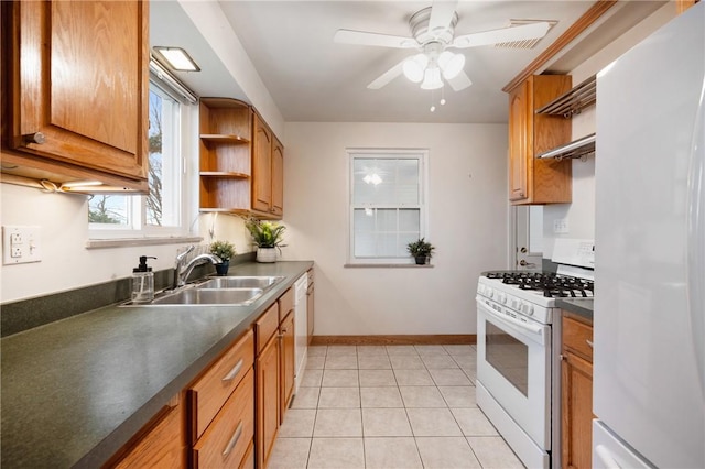 kitchen with ceiling fan, white appliances, sink, and light tile patterned floors