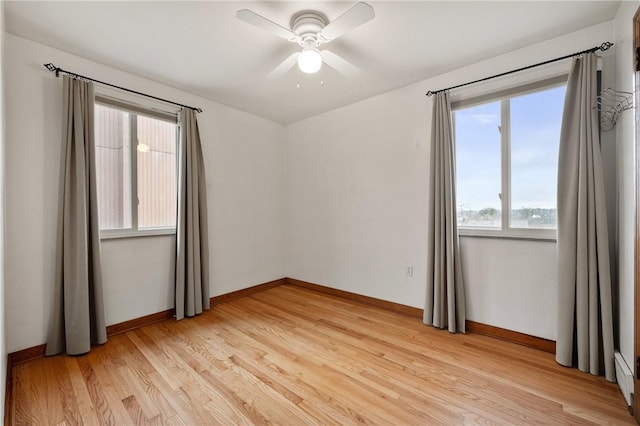 empty room featuring ceiling fan and light wood-type flooring