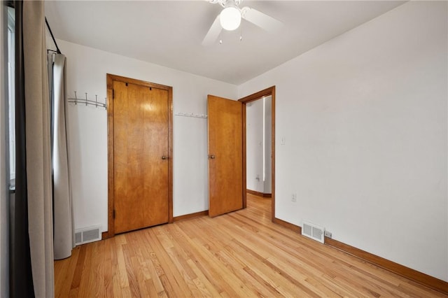 unfurnished bedroom featuring ceiling fan, light wood-type flooring, and a closet