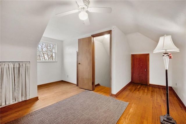 additional living space with vaulted ceiling, ceiling fan, and light hardwood / wood-style flooring