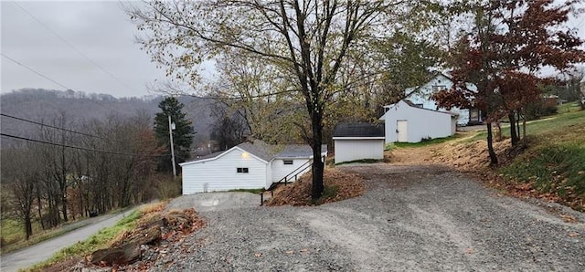 view of side of property featuring a shed