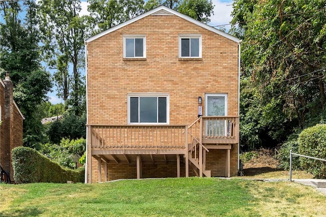 rear view of property featuring a lawn