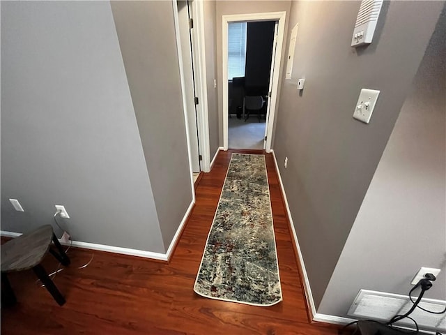 corridor with dark wood-type flooring